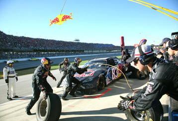 TALLADEGA, AL - NOVEMBER 01:  Brian Vickers, driver of the #83 Red Bull Toyota, makes a pit stop during the NASCAR Sprint Cup Series AMP Energy 500 at Talladega Superspeedway on November 1, 2009 in Talladega, Alabama.  (Photo by Jerry Markland/Getty Images for NASCAR)