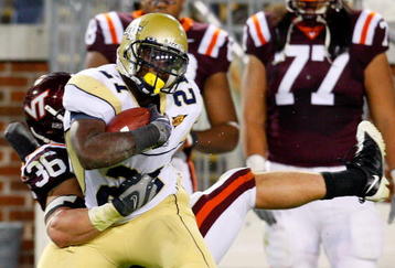 ATLANTA - OCTOBER 17:  Jonathan Dwyer #21 of the Georgia Tech Yellow Jackets rushes upfield against Jake Johnson #36 of the Virginia Tech Hokies at Bobby Dodd Stadium on October 17, 2009 in Atlanta, Georgia.  (Photo by Kevin C. Cox/Getty Images)