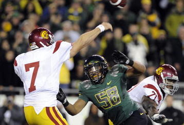 EUGENE, OR - OCTOBER 31: Quarterback Matt Barkley #7 of the USC Trojans gets off a pass as defensive end Will Tukuafu #39 applies pressure in the fourth quarter of the game at Autzen Stadium on October 31, 2009 in Eugene, Oregon. The Ducks upset the Trojans 47-20. (Photo by Steve Dykes/Getty Images)