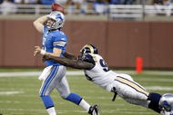 DETROIT , MI - NOVEMBER 01: Mathew Stafford #9 of the Detroit Lions tries to get a pass of before being tackled by James Hall #96 of the St. Louis Rams on November 1, 2009 at Ford Field in Detroit, Michigan. (Photo by Gregory Shamus/Getty Images)