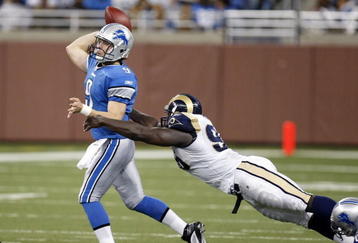 DETROIT , MI - NOVEMBER 01:  Mathew Stafford #9 of the Detroit Lions tries to get a pass of before being tackled by James Hall #96 of the St. Louis Rams on November 1, 2009 at Ford Field in Detroit, Michigan.  (Photo by Gregory Shamus/Getty Images)