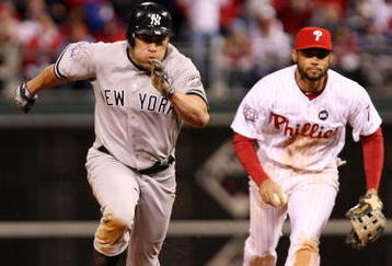 PHILADELPHIA - NOVEMBER 01:  Johnny Damon #18 (L) of the New York Yankees advances to third base after he stole second base in the top of the ninth inning against Pedro Feliz #7 of the Philadelphia Phillies in Game Four of the 2009 MLB World Series at Citizens Bank Park on November 1, 2009 in Philadelphia, Pennsylvania.  (Photo by Al Bello/Getty Images)