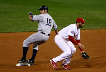 PHILADELPHIA - NOVEMBER 01:  Johnny Damon #18 of the New York Yankees steals second base in the top of the ninth inning against Pedro Feliz #7 of the Philadelphia Phillies in Game Four of the 2009 MLB World Series at Citizens Bank Park on November 1, 2009 in Philadelphia, Pennsylvania. Damon advanced to third on the play. (Photo by Chris McGrath/Getty Images)