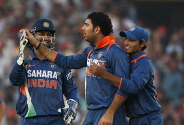 MOHALI, INDIA - NOVEMBER 02:  Yuvraj Singh is congratulated by his team mates MS Dhoni and Ravindra Jadeja of India after the wicket of Michael Hussey of Australia during the fourth One Day International match between India and Australia at Punjab Cricket Association Stadium on November 2, 2009 in Mohali, India.  (Photo by Mark Kolbe/Getty Images)
