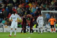 MADRID, SPAIN - OCTOBER 21:  Kaka (L) of Real Madrid stands dejected after conceding a goal as AC Milan players celebrate in the background during the Champions League group C match between Real Madrid and AC Milan at the Estadio Santiago Bernabeu on October 21, 2009 in Madrid, Spain. AC Milan won the match 3-2.  (Photo by Jasper Juinen/Getty Images)