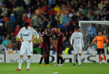 MADRID, SPAIN - OCTOBER 21:  Kaka (L) of Real Madrid stands dejected after conceding a goal as AC Milan players celebrate in the background during the Champions League group C match between Real Madrid and AC Milan at the Estadio Santiago Bernabeu on October 21, 2009 in Madrid, Spain. AC Milan won the match 3-2.  (Photo by Jasper Juinen/Getty Images)