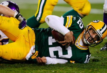 GREEN BAY, WI - NOVEMBER 01:  Quarterback Aaron Rodgers #12 of the Green Bay Packers is sacked during the third quarter of the game against the Minnesota Vikings at Lambeau Field on November 1, 2009 in Green Bay, Wisconsin. (Photo by Scott Boehm/Getty Images)