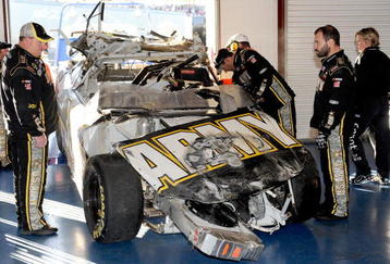 TALLADEGA, AL - NOVEMBER 01:  Crew chief Tony Gibson (L) looks over the #39 U.S Army Chevrolet, driven by Ryan Newman, in the garage after a car incident on track during the NASCAR Sprint Cup Series AMP Energy 500 at Talladega Superspeedway on November 1, 2009 in Talladega, Alabama.  (Photo by Rusty Jarrett/Getty Images for NASCAR)