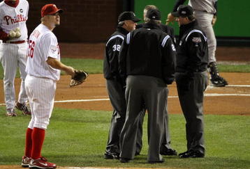 PHILADELPHIA - NOVEMBER 01:  The Umpire crew huddles up after Alex Rodriguez #13 (not pictured) of the New York Yankees was hit by a pitch thrown by Joe Blanton #56 (L) of the Philadelphia Phillies in Game Four of the 2009 MLB World Series at Citizens Bank Park on November 1, 2009 in Philadelphia, Pennsylvania.  (Photo by Jed Jacobsohn/Getty Images)