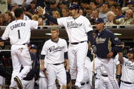 SAN DIEGO, CA - SEPTEMBER 30:  Everth Cabrera #1 of the San Diego Chargers is congratulated on scoring after being called to home by the umpire after third-baseman Mark Loretta #5 of the Los Angeles Dodgers impeded his movement with his legs during the MLB game between the Los Angeles Dodger and the San Diego Padres at Petco Park on September 30, 2009 in San Diego, California. (Photo by Donald Miralle/Getty Images)