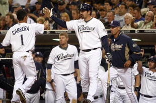 SAN DIEGO, CA - SEPTEMBER 30: Everth Cabrera #1 of the San Diego Chargers is congratulated on scoring after being called to home by the umpire after third-baseman Mark Loretta #5 of the Los Angeles Dodgers impeded his movement with his legs during the MLB game between the Los Angeles Dodger and the San Diego Padres at Petco Park on September 30, 2009 in San Diego, California. (Photo by Donald Miralle/Getty Images)