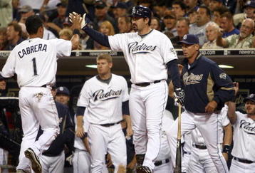 SAN DIEGO, CA - SEPTEMBER 30:  Everth Cabrera #1 of the San Diego Chargers is congratulated on scoring after being called to home by the umpire after third-baseman Mark Loretta #5 of the Los Angeles Dodgers impeded his movement with his legs during the MLB game between the Los Angeles Dodger and the San Diego Padres at Petco Park on September 30, 2009 in San Diego, California. (Photo by Donald Miralle/Getty Images)