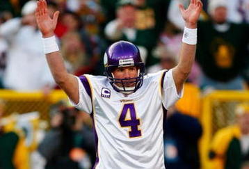 GREEN BAY, WI - NOVEMBER 01: Quarterback Brett Favre #4 of the Minnesota Vikings signals touchdown after teammate Adrian Petersen #20 scored during the first quarter of the game against the Green Bay Packers at Lambeau Field on November 1, 2009 in Green Bay, Wisconsin. (Photo by Scott Boehm/Getty Images)
