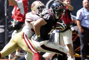 HOUSTON - OCTOBER 25:  Tight end Owen Daniels #81 of the Houston Texans scores as he breaks the tackle of cornerback Shawntae Spencer #36 of the San Francisco 49ers at Reliant Stadium on October 25, 2009 in Houston, Texas.  (Photo by Bob Levey/Getty Images)