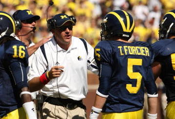 ANN ARBOR, MI - SEPTEMBER 19:  Head coach Rich Rodriguez of the Michigan Wolverines talks with quarterback Tate Forcier #5 during the game with the Eastern Michigan Eagles at Michigan Stadium on September 19, 2009 in Ann Arbor, Michigan.  Michigan won 45-17.  (Photo by Stephen Dunn/Getty Images)