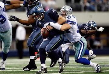 ARLINGTON, TX - NOVEMBER 01:  Quarterback Matt Hasselbeck #8 of the Seattle Seahawks is sacked by Bobby Carpenter #54 of the Dallas Cowboys at Cowboys Stadium on November 1, 2009 in Arlington, Texas.  (Photo by Ronald Martinez/Getty Images)