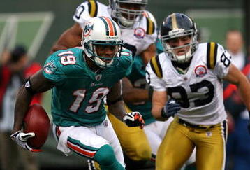 EAST RUTHERFORD, NJ - NOVEMBER 01:  Ted Ginn #19 of the Miami Dolphins returns a kick off during a game against the New York Jets at Giants Stadium on November 1, 2009 in East Rutherford, New Jersey.  (Photo by Chris Trotman/Getty Images)