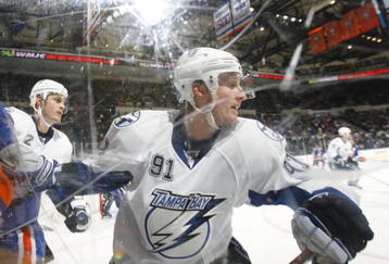 UNIONDALE, NY - APRIL 04: Steven Stamkos #91 of the Tampa Bay Lightning turning away from a check against the New York Islanders in a National Hockey League game at Nassau Coliseum on April 4, 2009 in Uniondale, New York. (Photo by Paul Bereswill/Getty Images)