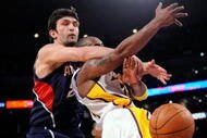 LOS ANGELES, CA - NOVEMBER 01:  Kobe Bryant #24 (R)  of the Los Angeles Lakers is fouled by Zaza Pachulia #27 of the Atlanta Hawks during the NBA basketball game at Staples Center on November 1, 2009 in Los Angeles, California. NOTE TO USER: User expressly acknowledges and agrees that, by downloading and/or using this Photograph, user is consenting to the terms and conditions of the Getty Images License Agreement.  (Photo by Kevork Djansezian/Getty Images)