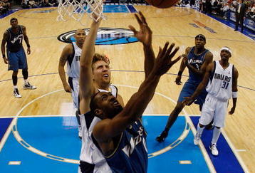 DALLAS - OCTOBER 27:  Guard Gilbert Arenas #0 of the Washington Wizards takes a shot against Dirk Nowitzki #41 of the Dallas Mavericks during the season opener on October 27, 2009 at American Airlines Center in Dallas, Texas.  NOTE TO USER: User expressly acknowledges and agrees that, by downloading and/or using this Photograph, user is consenting to the terms and conditions of the Getty Images License Agreement.  (Photo by Ronald Martinez/Getty Images)
