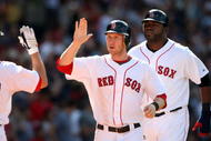 BOSTON - JULY 05:  Jason Bay #44 and David Ortiz #of the Boston Red Sox are congratulated after they scored off a hit by Mark Kotsay in the seventh inning against the Seattle Mariners on July 5, 2009 at Fenway Park in Boston, Massachusetts. The Red Sox defeated the Mariners 8-4.  (Photo by Elsa/Getty Images)