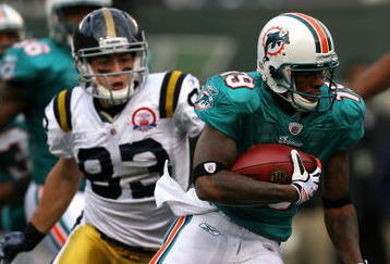 EAST RUTHERFORD, NJ - NOVEMBER 01:  Ted Ginn #19 of the Miami Dolphins returns a kick off for a touchdown against the New York Jets at Giants Stadium on November 1, 2009 in East Rutherford, New Jersey.  (Photo by Chris Trotman/Getty Images)