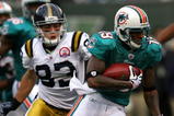 EAST RUTHERFORD, NJ - NOVEMBER 01:  Ted Ginn #19 of the Miami Dolphins returns a kick off for a touchdown against the New York Jets at Giants Stadium on November 1, 2009 in East Rutherford, New Jersey.  (Photo by Chris Trotman/Getty Images)