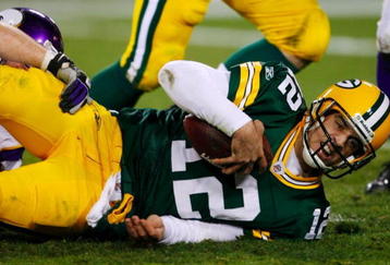 GREEN BAY, WI - NOVEMBER 01:  Quarterback Aaron Rodgers #12 of the Green Bay Packers is sacked during the third quarter of the game against the Minnesota Vikings at Lambeau Field on November 1, 2009 in Green Bay, Wisconsin. (Photo by Scott Boehm/Getty Images)