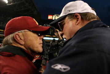 SEATTLE - JANUARY 05:  Head coach Joe Gibbs of the Washington Redskins speaks with head coach Mike Holmgren of the Seattle Seahawks after the Seahawks defeated the Redskins 35-14 after the NFC Wild Card game at Qwest Field on January 5, 2008 in Seattle, Washington.  (Photo by Otto Greule Jr/Getty Images)