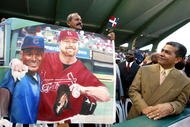 SAN JUAN, PUERTO RICO - SEPTEMBER 9:  ***PUERTO RICO OUT***INTERNET OUT**  Orlando Doble, a native of San Pedro de Macoris in the Domincan Republic, carries a painting of Sammy Sosa #21 of the Chicago Cubs and former St. Louis Cardinal Mark McGwire prior to the Cubs game against the Montreal Expos September 9, 2003 at Hiram Bithorn Stadium in San Juan, Puerto Rico. This is Sosa's first appearance on the island as a member of the Chicago Cubs.  (Jose Jimenez/Primera Hora/Getty Images)