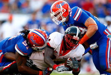 JACKSONVILLE, FL - OCTOBER 31:  Brandon Spikes #51 and Duke Lemmens #44 of the Florida Gators tackle Washaun Ealey #24 of the Georgia Bulldogs at Jacksonville Municipal Stadium on October 31, 2009 in Jacksonville, Florida.  (Photo by Kevin C. Cox/Getty Images)