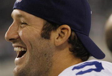 ARLINGTON, TX - AUGUST 21:  Quarterback Tony Romo #9 of the Dallas Cowboys laughs with teammates in the fourth quarter against the Tennessee Titans during a preseason game at Dallas Cowboys Stadium on August 21, 2009 in Arlington, Texas. (Photo by Tom Pennington/Getty Images) 