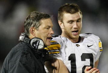 STATE COLLEGE, PA - SEPTEMBER 26:  Head coach Kirk Ferentz of the Iowa Hawkeyes talks with Ricky Stanzi #12 while playing the Penn State Nittnay Lions  on September 26, 2009 at Beaver Stadium in State College, Pennsylvania. Iowa won the game 21-10. (Photo by Gregory Shamus/Getty Images)
