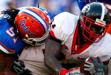 JACKSONVILLE, FL - OCTOBER 31:  Brandon Spikes #51 and Duke Lemmens #44 of the Florida Gators tackle Washaun Ealey #24 of the Georgia Bulldogs at Jacksonville Municipal Stadium on October 31, 2009 in Jacksonville, Florida.  (Photo by Kevin C. Cox/Getty Images)