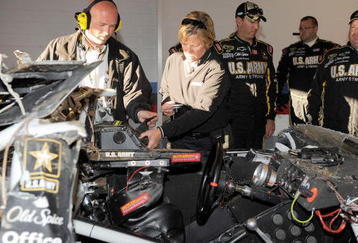 TALLADEGA, AL - NOVEMBER 01:  Crew chief Tony Gibson (R) looks over the #39 U.S Army Chevrolet, driven by Ryan Newman, in the garage after a car incident on track during the NASCAR Sprint Cup Series AMP Energy 500 at Talladega Superspeedway on November 1, 2009 in Talladega, Alabama.  (Photo by Rusty Jarrett/Getty Images for NASCAR)
