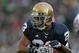 SOUTH BEND, IN - OCTOBER 03: Golden Tate #23 of the Notre Dame Fighting Irish attempts to break away from a Washington Huskie tackler on October 3, 2009 at Notre Dame Stadium in South Bend, Indiana. Notre Dame defeated Washington 37-30 in overtime. (Photo by Jonathan Daniel/Getty Images)