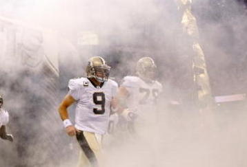 NEW ORLEANS - OCTOBER 18:  Drew Brees #9 of the New Orleans Saints runs onto the field during player introductions before playing the New York Giants at the Louisiana Superdome on October 18, 2009 in New Orleans, Louisiana.  (Photo by Chris Graythen/Getty Images)
