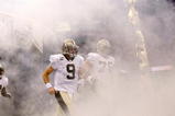 NEW ORLEANS - OCTOBER 18:  Drew Brees #9 of the New Orleans Saints runs onto the field during player introductions before playing the New York Giants at the Louisiana Superdome on October 18, 2009 in New Orleans, Louisiana.  (Photo by Chris Graythen/Getty Images)