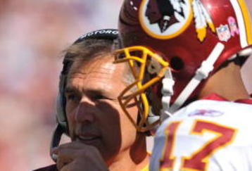 LANDOVER, MD - OCTOBER 4:  Head coach Jim Zorn speaks with Jason Campbell #17 of the Washington Redskins during a time out against the Tampa Bay Buccaneers at FedExField on October 4, 2009 in Landover, Maryland. The Redskins defeated the Buccaneers 16-13. (Photo by Larry French/Getty Images)