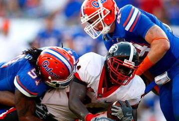 JACKSONVILLE, FL - OCTOBER 31:  Brandon Spikes #51 and Duke Lemmens #44 of the Florida Gators tackle Washaun Ealey #24 of the Georgia Bulldogs at Jacksonville Municipal Stadium on October 31, 2009 in Jacksonville, Florida.  (Photo by Kevin C. Cox/Getty Images)