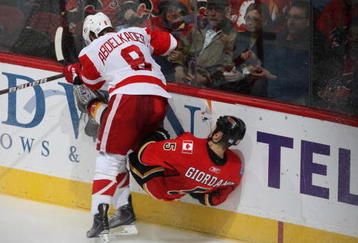 CALGARY, CANADA - OCTOBER 31:   Justin Abdelkader #8 of the Detroit Red Wings checks Mark Giordano #5 the Calgary Flames on October 31st, 2009 at the Pengrowth Saddledome in Calgary, Alberta, Canada. (Photo by Dale MacMillan/Getty Images)