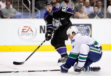 LOS ANGELES, CA - OCTOBER 29:  Scott Parse #63 of the Los Angeles Kings passes the puck past Kevin Bieksa #3 of the Vancouver Canucks in the second period at Staples Center on October 29, 2009 in Los Angeles, California.  (Photo by Jeff Gross/Getty Images)