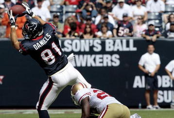 HOUSTON - OCTOBER 25:  Tight-end Owen Daniels #81 of the Houston Texans completes a pass in front of safety Mark Roman #26 of the San Francisco 49ers at Reliant Stadium on October 25, 2009 in Houston, Texas.  (Photo by Bob Levey/Getty Images)