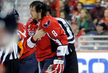 WASHINGTON - NOVEMBER 01:  Alex Ovechkin #8 of the Washington Capitals holds his shoulder as he is escorted to the penalty box after receiving a roughing penalty in the second period against the Columbus Blue Jackets at the Verizon Center on November 1, 2009 in Washington, DC.  (Photo by Greg Fiume/Getty Images)