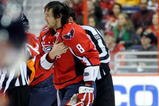 WASHINGTON - NOVEMBER 01:  Alex Ovechkin #8 of the Washington Capitals holds his shoulder as he is escorted to the penalty box after receiving a roughing penalty in the second period against the Columbus Blue Jackets at the Verizon Center on November 1, 2009 in Washington, DC.  (Photo by Greg Fiume/Getty Images)