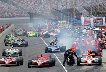 INDIANAPOLIS - MAY 24:  Scott Dixon (left) driver of the #9 Target Chip Ganassi Dallara Honda and his teamate Dario Franchitti come out of the pits ahead of Helio Castroneves during the IRL IndyCar Series 93rd running of the Indianapolis 500 at the Indianapolis Motor Speedway on May 24, 2009 in Indianapolis, Indiana.  (Photo by Robert Laberge/Getty Images)