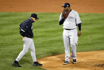 PHILADELPHIA - NOVEMBER 01:  Manager Joe Girardi of the New York Yankees walks out to talk to starting pitcher C.C. Sabathia #52 in the bottom of the first inning against the Philadelphia Phillies in Game Four of the 2009 MLB World Series at Citizens Bank Park on November 1, 2009 in Philadelphia, Pennsylvania.  (Photo by Nick Laham/Getty Images)