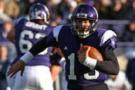 EVANSTON, IL - OCTOBER 31: Mike Kafka #13 of the Northwestern Wildcats runs for a first down against the Penn State Nittany Lions at Ryan Field on October 31, 2009 in Evanston, Illinois. (Photo by Jonathan Daniel/Getty Images)
