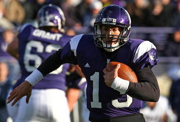 EVANSTON, IL - OCTOBER 31: Mike Kafka #13 of the Northwestern Wildcats runs for a first down against the Penn State Nittany Lions at Ryan Field on October 31, 2009 in Evanston, Illinois. (Photo by Jonathan Daniel/Getty Images)