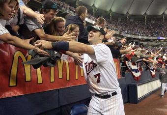 MINNEAPOLIS - OCTOBER 06:  Joe Mauer #7 of the Minnesota Twins celebrates with fans after winning the American League tiebreaker game against the Detroit Tigers on October 6, 2009 at Hubert H. Humphrey Metrodome in Minneapolis, Minnesota. (Photo by Jamie Squire/Getty Images)